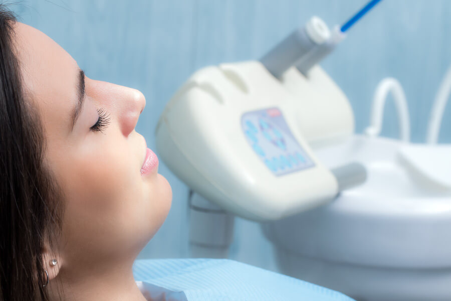 A woman relaxing in the dental chair after receiving dental sedation.