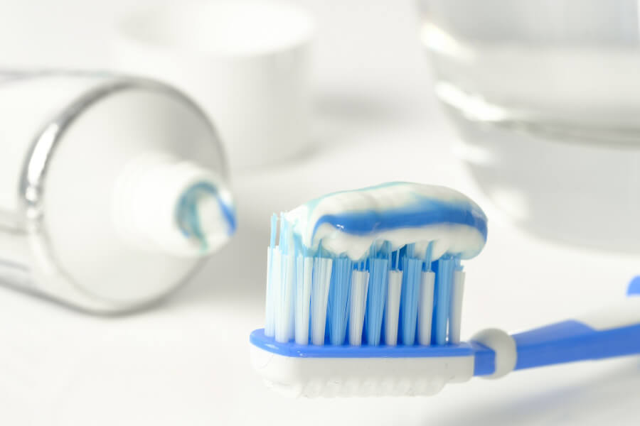 Fluoride toothpaste loaded onto a toothbrush.